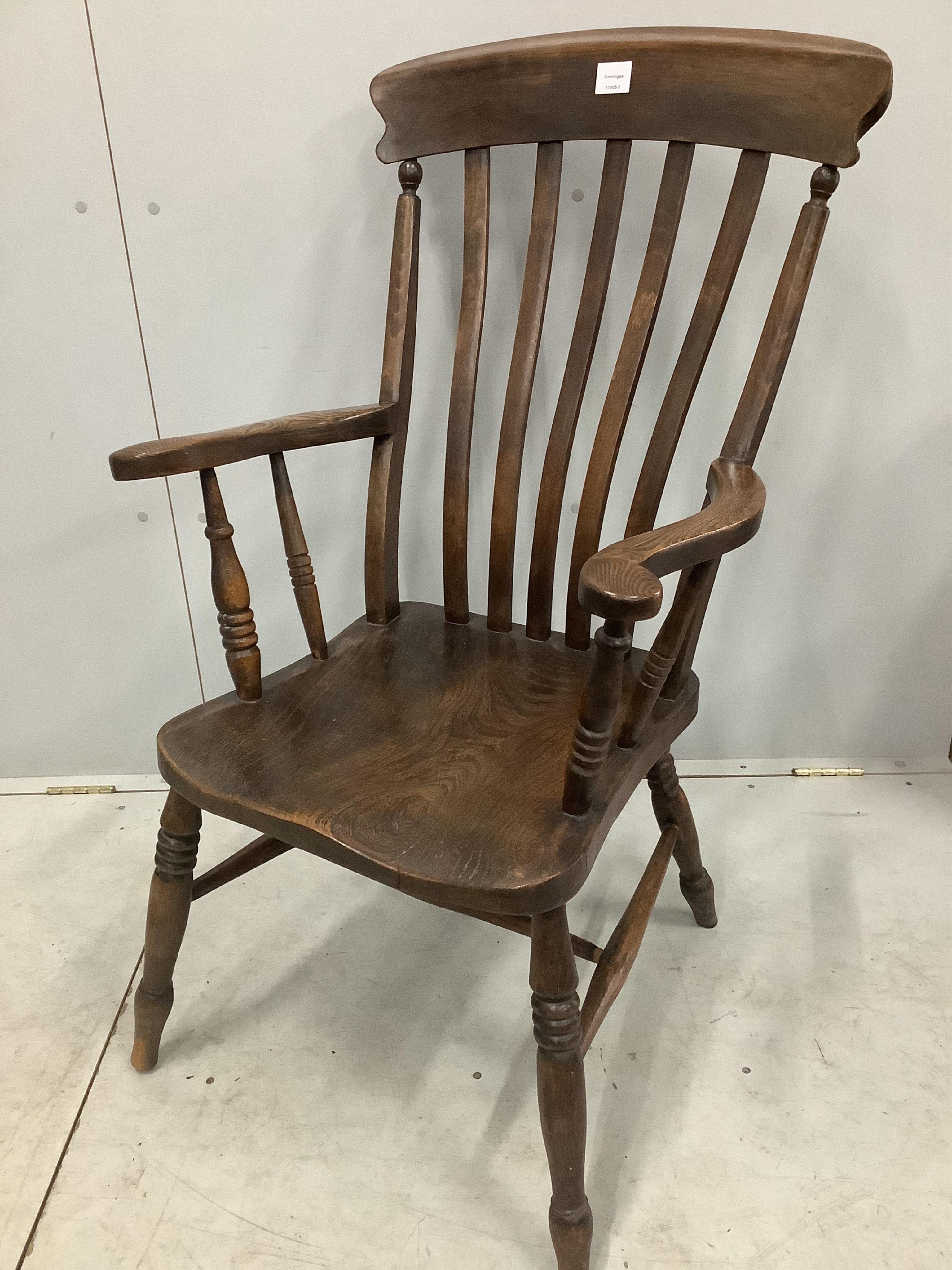 Two 19th century Windsor elm and beech lathe back armchairs, larger width 58cm, depth 48cm, height 110cm. Condition - fair